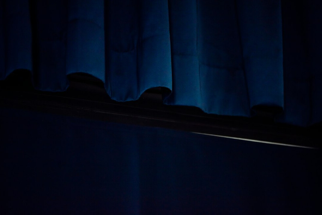 Heavy deep blue velvet stage curtain with soft folds and light