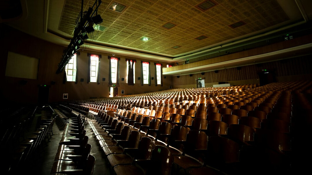 Empty elegant auditorium with rows of seats and dramatic lighting
