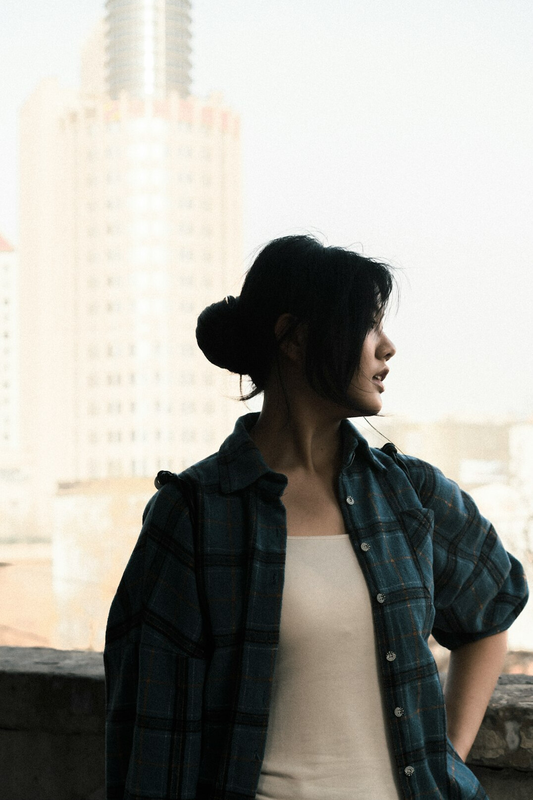 Portrait of a woman with dark hair tied back in a light shirt