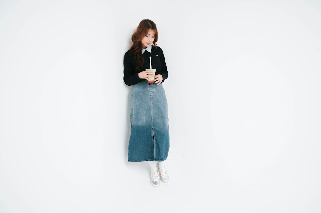 Businesswoman standing upright with calm posture in a bright studio