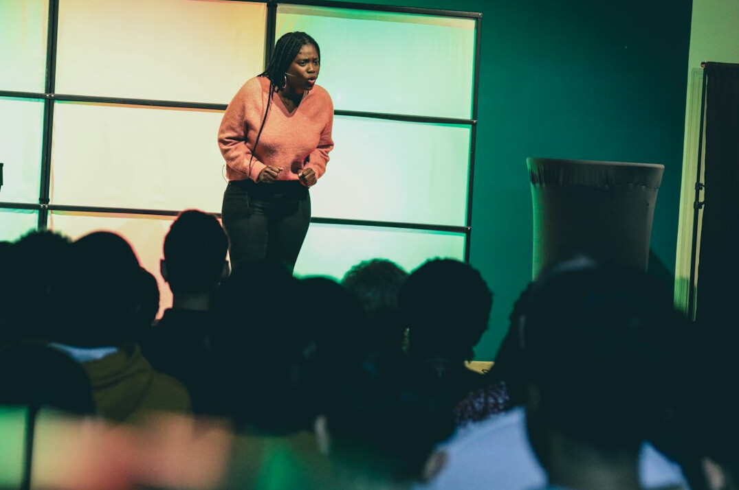 man speaking to large audience