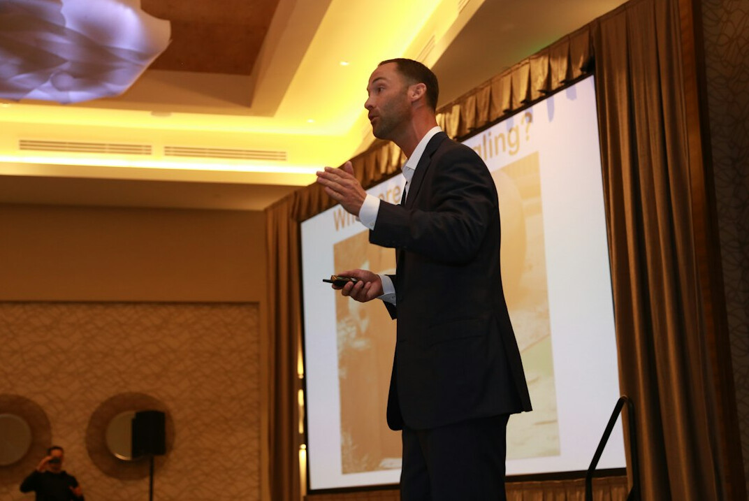 executive on stage presenting
